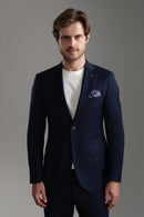Navy suit jacket featuring a tailored fit, worn by a man with a white shirt, showcasing a sophisticated look.
